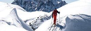 Power Ski - Mann auf Tourenski wandert über idyllische Bergkuppe